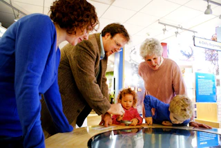 Family at an exhibit inside the Albany Pine Bush Discovery Center