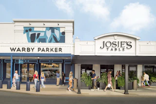 Shoppers walking past Warby Parker and Josie's Table at Stuyvesant Plaza in Albany, New York